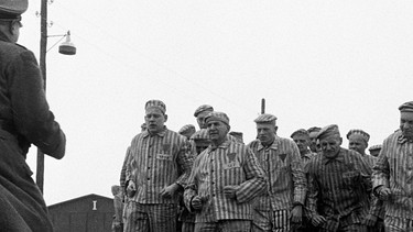 Dieser Bericht, geschrieben von Gunther R. Lys, der selbst jahrelang politischer Häftling in Sachsenhausen war, schildert den Ablauf eines Tages in einem KZ. Auf Befehl des Blockführers Schwarz (Peter Lehmbrock) singen die Häftlinge "Und Juda den Tod" | Bild: NDR