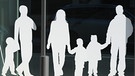 Weißer Pappausschnitt einer Patchwork-Familie, mit drei Kindern, zwei Vätern und einer Mutter. | Bild: picture-alliance/dpa