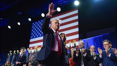 06.11.2024, USA, West Palm Beach: Der republikanische Präsidentschaftskandidat und frühere Präsidentschaftskandidat Donald Trump winkt, während er mit der ehemaligen First Lady Melania Trump bei einer Wahlparty im Palm Beach Convention Center am Mittwoch, 6. November 2024, in West Palm Beach, Florida, über die Bühne geht.
Donald Trump wird wohl zum zweiten Mal Präsident der USA. (zu dpa: «Ampel-Showdown unter dem Eindruck des Trump-Siegs») Foto: Evan Vucci/AP/dpa +++ dpa-Bildfunk +++ | Bild: dpa-Bildfunk/Evan Vucci