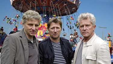 Ermitteln auf der Wiesn: die Münchner Kommissare Franz Leitmayr (Udo Wachtveitl, links), Carlo Menzinger (Michael Fitz, Mitte) und Ivo Batic (Miroslav Nemec). [Fotomontage]. | Bild: BR/Moovie-the art of entertainment GmbH/Laurent Trümper