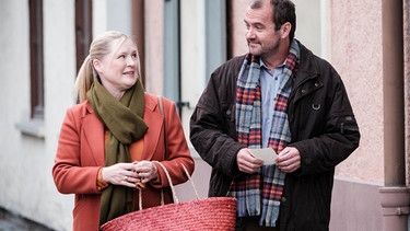 Vera (Sybille Waury) unterhält sich mit Eberhard (Philipp Rafferty) auf dem Weg zur Bushaltestelle über ihren Herzschmerz, den sie wegen Gregor hat. | Bild: BR/Lena Semmelroggen