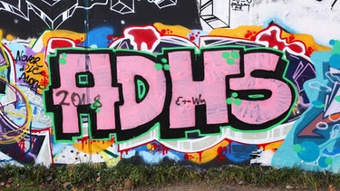 Die Buchstaben eines Graffitis ergeben "ADHS". | Bild: picture-alliance/dpa