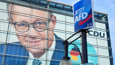 Ein Wahlplakat der AfD hängt vor dem Konrad-Adenauer-Haus mit dem Konterfei des CDU-Bundesvorsitzenden Merz. | Bild: picture alliance/dpa | Michael Kappeler