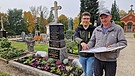 Bernd Müller, Leiter des Standesamtes Amberg, und Friedhofspfleger Stefan Ferstl vor einem gerade sanierten und zu einem Urnengrab umgewandelten historischen Grab auf dem Katharinenfriedhof in Amberg. | Bild: BR / Julia Grantner