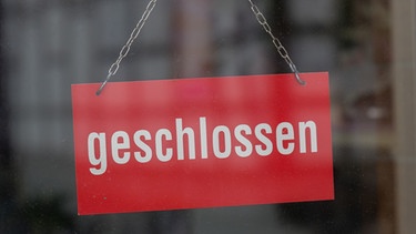 Nahaufnahme eines Schildes "Geschlossen" an einer Ladentür. | Bild: stock.adobe.com/Corinna