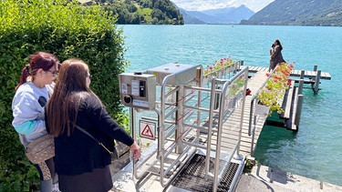 Um dem Massentourismus im Schweizer Dorf Iseltwald entgegenzuwirken, wurde ein Bezahl-Drehkreuz vor dem Steg aufgebaut, auf den die Fans einer Netflix-Serie pilgern. | Bild: SWR