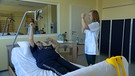 Auszubildende Physiotherapeutin und Frau auf Liege | Bild: Bayerischer Rundfunk 2024