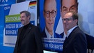 Politiker vor einem Plakat | Bild: Bayerischer Rundfunk 2024