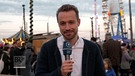 BR-Reporter Manuel Rauch berichtet von der Wiesn | Bild: Bayerischer Rundfunk 2024