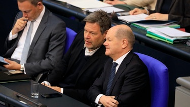 Die Ampel-Koalition ist gescheitert: Auf diesem Bild sitzt Bundeskanzler Olaf Scholz (SPD) noch gemeinsam mit Vizekanzler Robert Habeck (Die Grünen) auf der Regierungsbank im Bundestag. Daneben sitzt Finanzminister Christian Lindner (FDP), der am 6.11.2024 entlassen wurde.  | Bild: dpa-Bildfunk/BPI Bundesverband der Pharmazeut