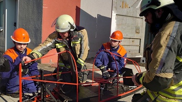 Lukas und Philipp schrauben im FSSJ auch an der Seifenkiste der Freiwilligen Feuerwehr Neuhaus an der Aisch. | Bild: BR / Ulrike Nikola