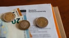 Ein Brief der Deutschen Rentenversicherung in einem Ordner mit Geld. | Bild: BR