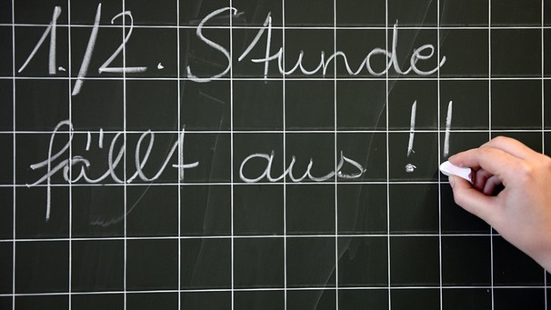 Eine Lehrerin schreibt am 19.03.2014 in einer Grundschule, «1./2. Stunde fällt aus!!» an die Tafel. Die GEW befürchtet wegen des Lehrermangels an Sachsens Schulen eine wachsende Chancenungerechtigkeit. Foto: Caroline Seidel/dpa (zu dpa «GEW befürchtet Chancenungerechtigkeit durch Lehrerm... | Bild: picture-alliance/dpa