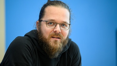 ARCHIV - 06.10.2022, Berlin: Arne Semsrott stellt in der Bundespressekonferenz einen Entwurf eines Bundestransparenzgesetzes vor. Der Journalist und Aktivist steht in Berlin vor Gericht, weil er Dokumente aus einem laufenden Ermittlungsverfahren gegen die Klimaschutzgruppe Letzte Generation veröffentlicht haben soll. (zu dpa: «Gerichtsdokumente veröffentlicht - Journalist vor Gericht») Foto: Bernd von Jutrczenka/dpa +++ dpa-Bildfunk +++ | Bild: dpa-Bildfunk/Bernd von Jutrczenka