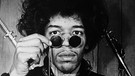 Jimi Hendrix mit Brille auf der Nase guckt in die Kamera | Bild: picture-alliance/dpa