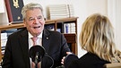 Joachim Gauck sitzt an einem Tisch und lächelt - ihm gegenüber sitzt die Autorin Katja Strippel | Bild: BR/Katja Strippel