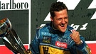 Michael Schumacher ist erneut Weltmeister. Nach dem Triumph beim Großen Pazifik-Pokal im japanischen Aida jubelt der deutsche Formel-1-Pilot mit dem Siegespokal in der Hand (Archivfoto vom 22.10.95) | Bild: dpa-Bildfunk