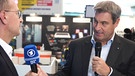MTM2022: Steffen Jenter, der Leiter der Radio-Redaktion BR24 im Gespräch mit Ministerpräsident Markus Söder.  | Bild: BR