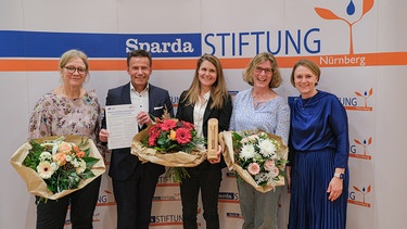 v. l.: Angelika Schmaus (Laudatorin und Vorjahresgewinnerin), Thomas Lang (Vorsitzender des Stiftungsvorstandes), Susanne Wimmer (Bayerischer Rundfunk), Veronika Baum (Laudatorin und Vorjahresgewinnerin) und Silvia Renauer (Bayerischer Rundfunk)  | Bild: Sparda-Stiftung Nürnberg